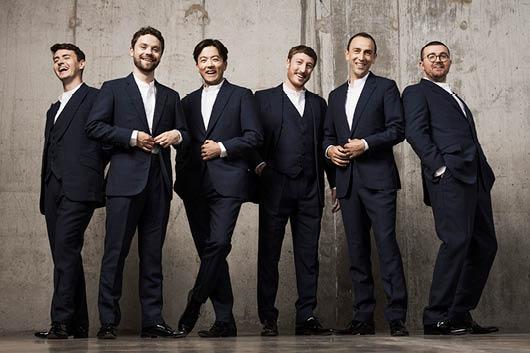 6 men standing in black suits